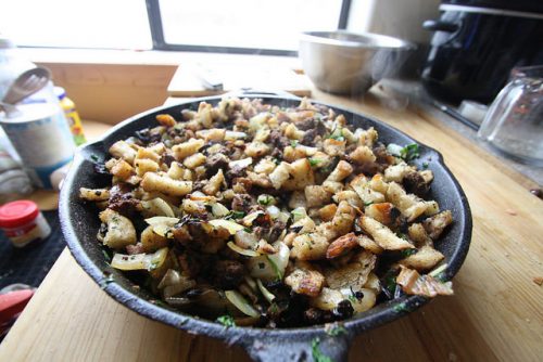 Stuffing before being placed in the oven. Although cast iron is great for baking, it tends to burn the bottom of the stuffing. Glass is preferred.