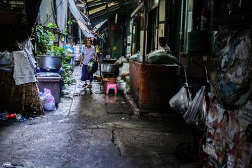 A woman holds a pot in alley, Dec. 4, 2015 in Bangkok, Thailand. I really like alleys.