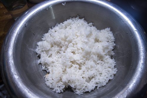 The rice in a stainless steel bowl, after it's been cooked, but before the vinegar has been added.